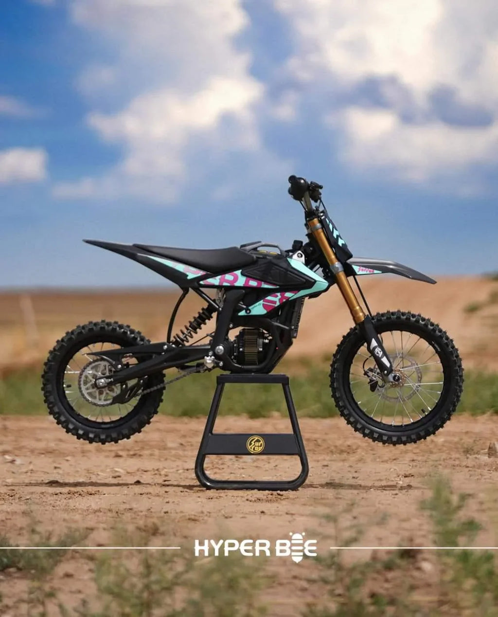 Small dirt bike on a stand with a clear sky background, featuring the brand 'Hyper Bee'.