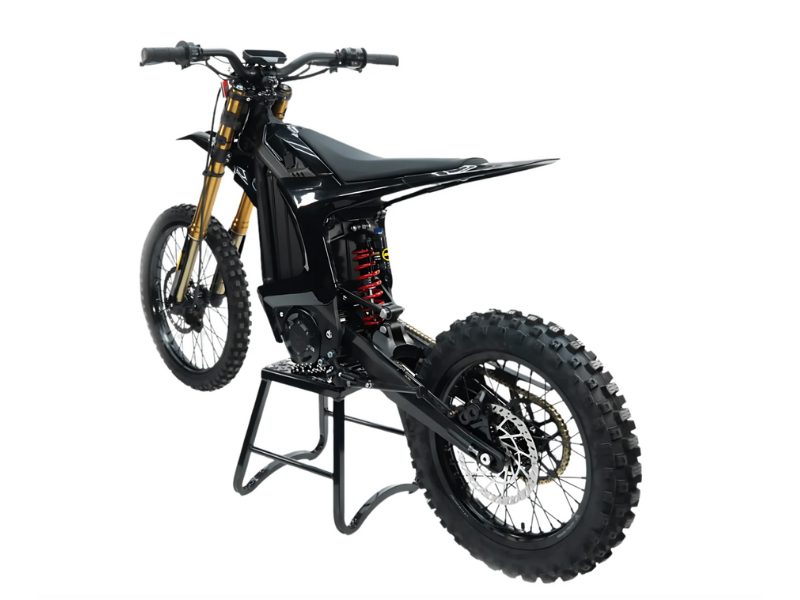 Black off-road motorcycle on a stand against a white background
