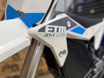 Close-up of a motorcycle with 'ETM' branding on the fender.