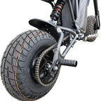 Close-up of a scooter wheel with suspension system on a white background