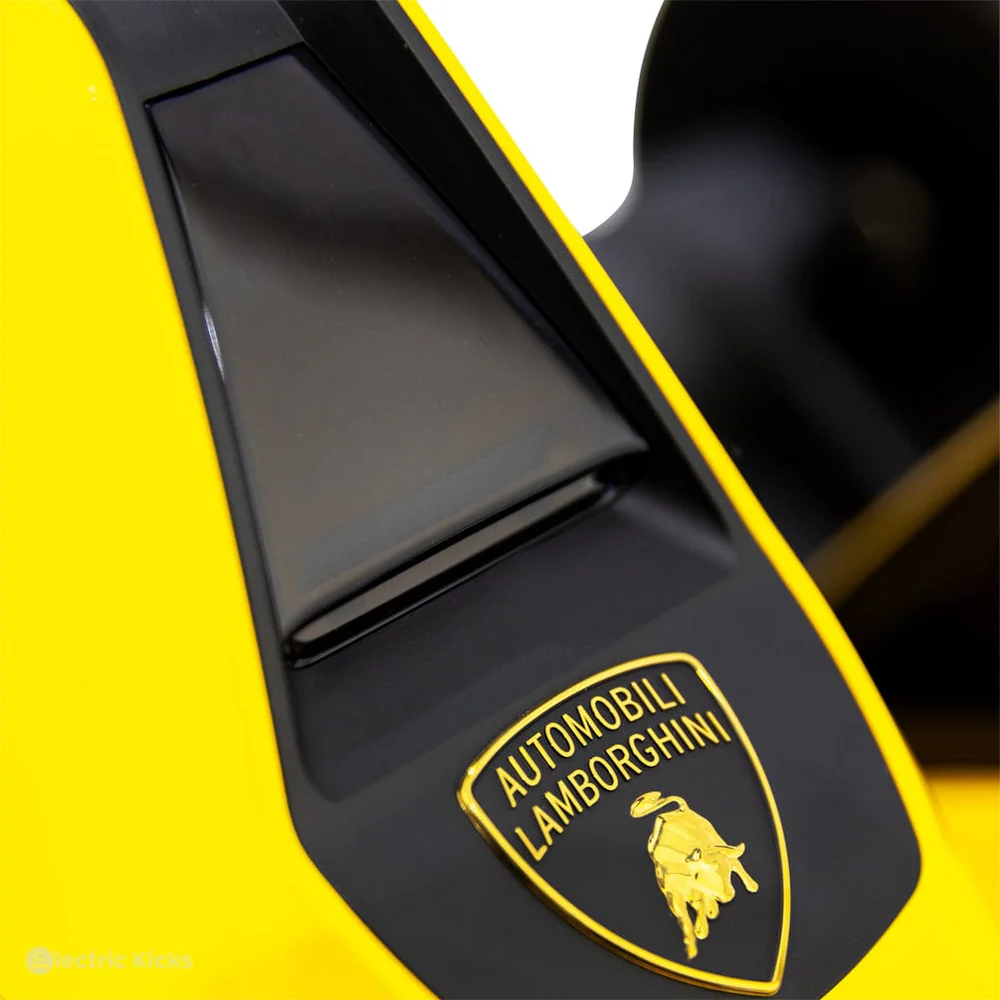 Close-up of a Lamborghini logo on a yellow go kart.
