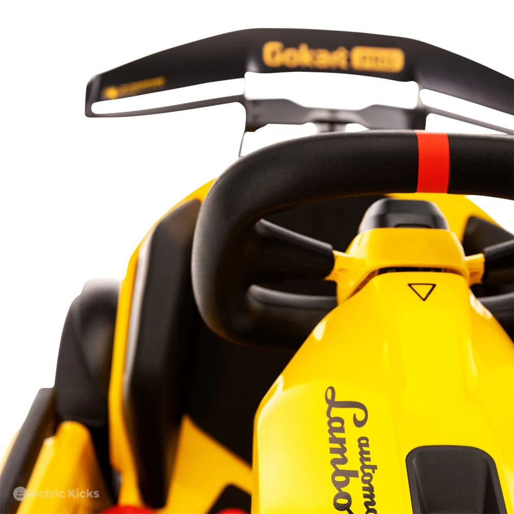 Close-up of a yellow and black go-kart with 'Lamborghini' branding on a white background.