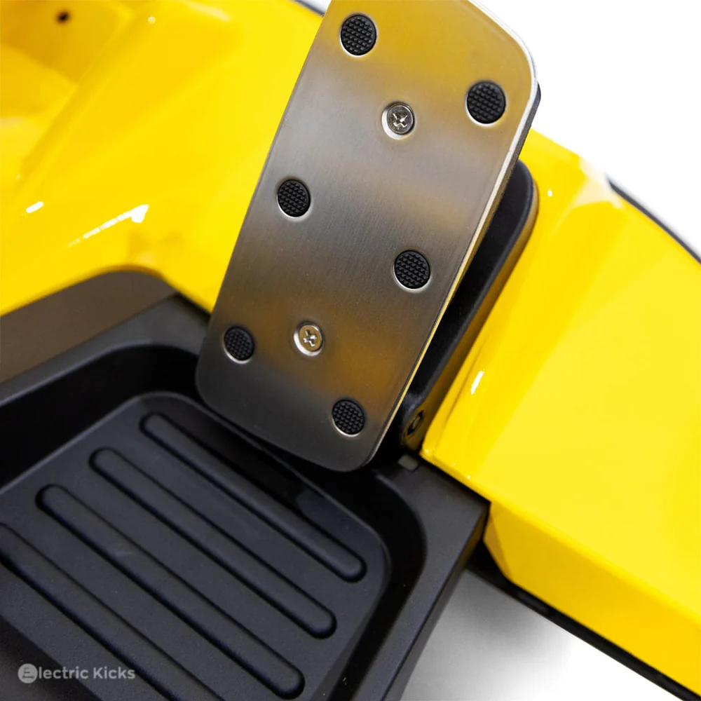 Close-up of a yellow scooter with a metal footrest and black.