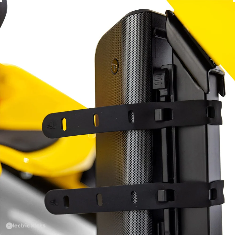 Close-up of a black bike mount on a yellow bicycle with a white background.